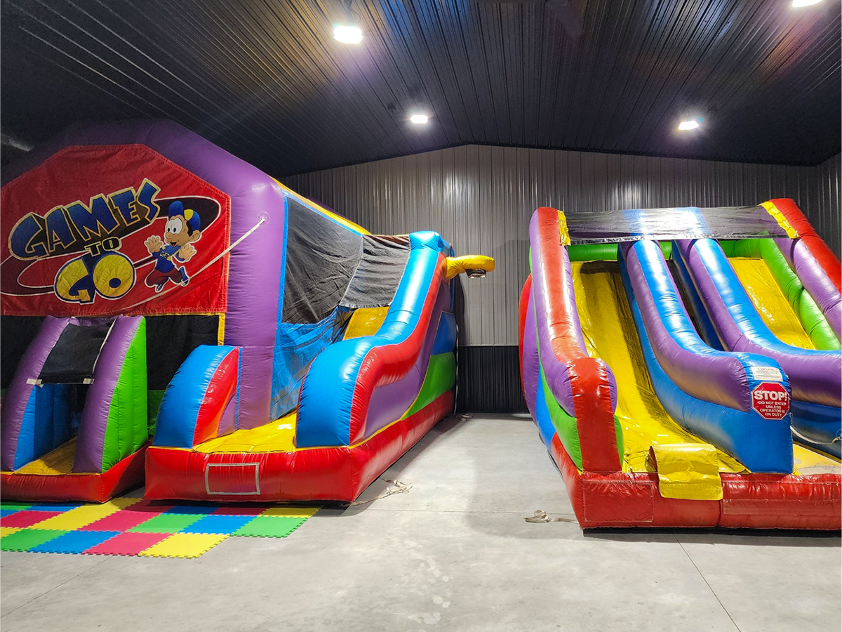 Two inflatable slides inside a building.